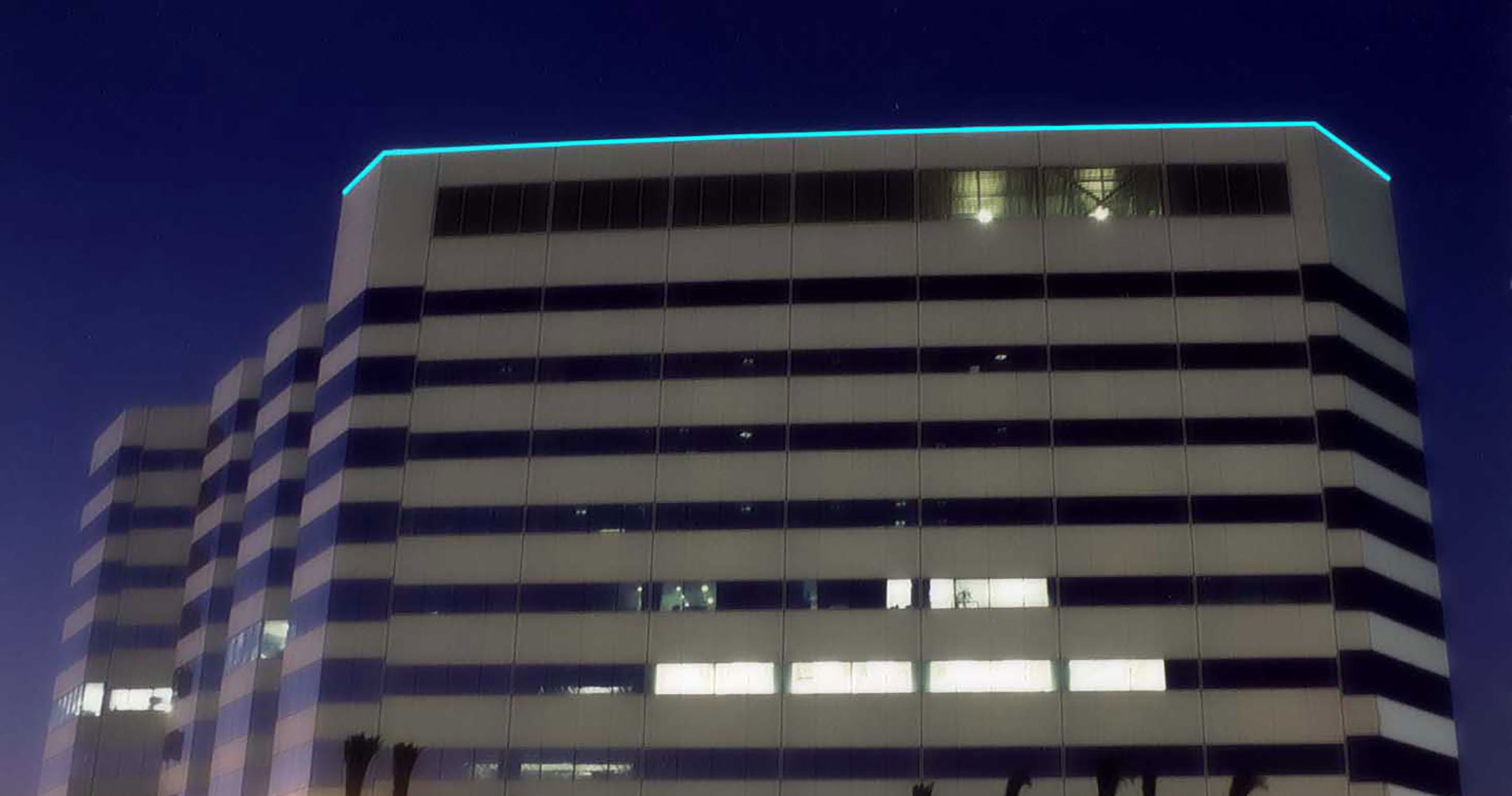 Office building outlined with linear fiber optic lighting